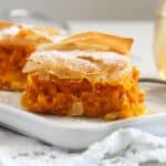 slice of creamy filo pumpkin pie on a long cake platter.