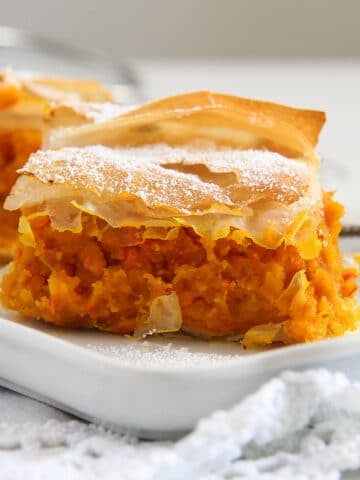 slice of creamy filo pumpkin pie on a long cake platter.