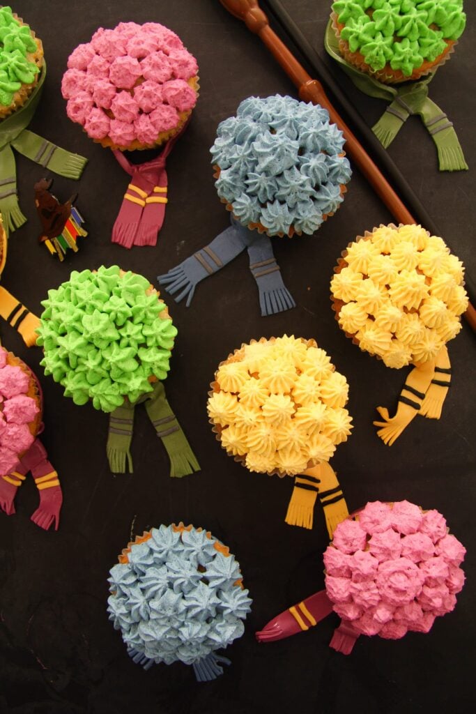 yellow, red, green and blue decorated cupcakes