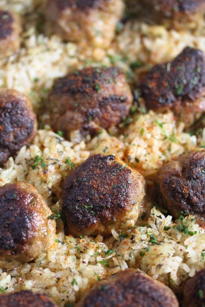 brown meatballs with rice and sprinkled with parsley