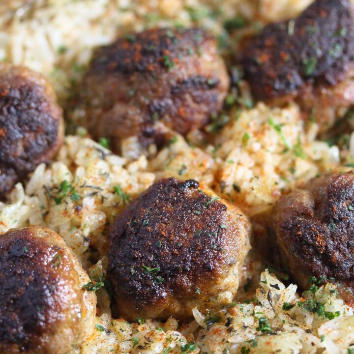 brown meatballs with rice and sprinkled with parsley