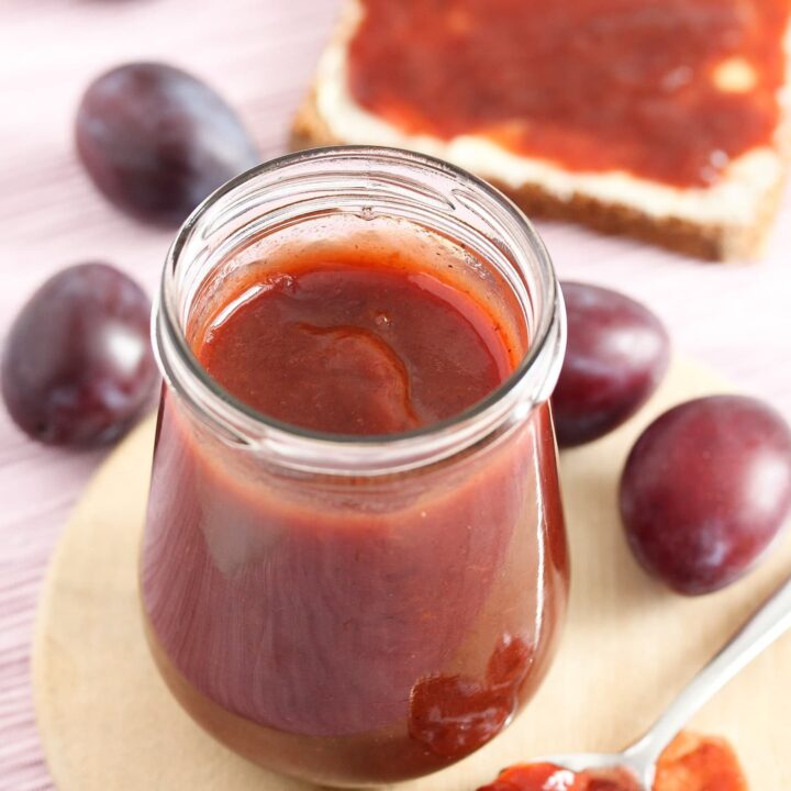 german plum butter on a wooden board on a pink cloth