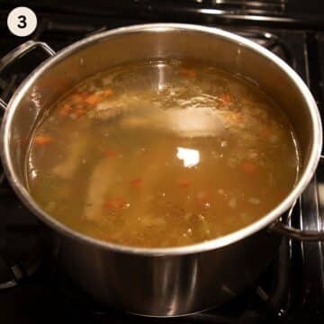 pork ribs and beans cooking in a large pot to make soup.