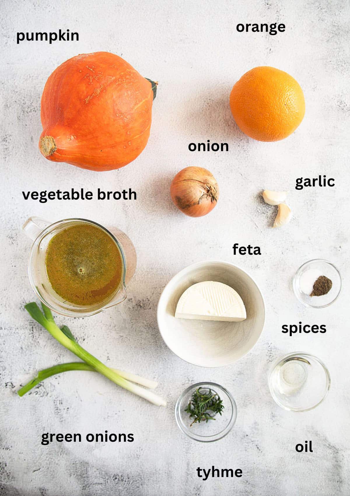 listed ingredients for making soup with pumpkin, orange, feta and green onion topping.