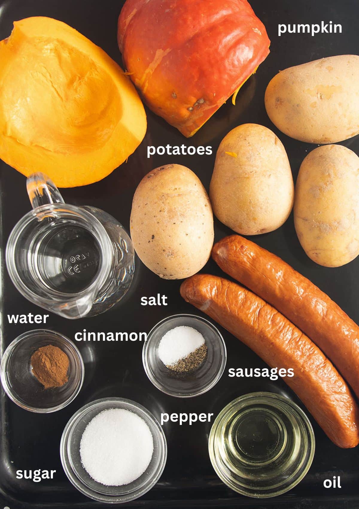 labeled ingredients for making sheet pan with pumpkin, sausages, and potatoes.