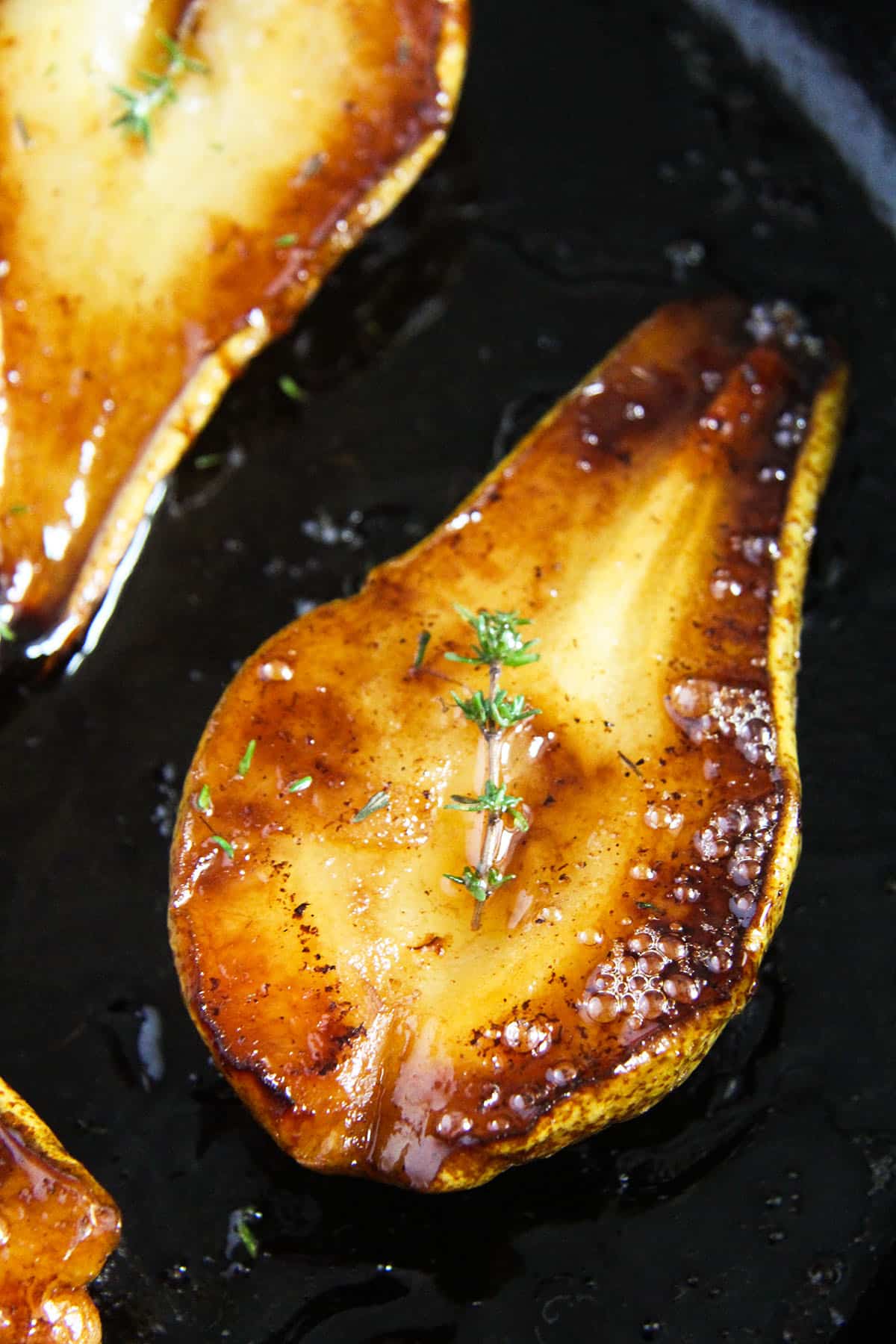 one roasted pear half in a skillet.