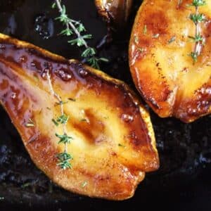 two roasted pears caramelized and drizzled with honey.