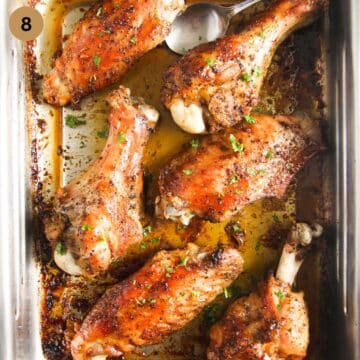 golden brown roasted turkey wings in a baking tin.