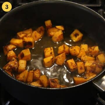 brown sauteed sweet potatoes in a skillet.