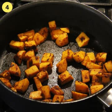 browned sweet potato cubes in a pan.
