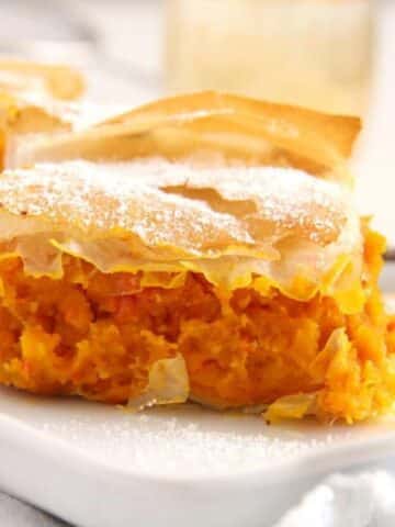 skinny filo pumpkin pie sliced on a platter.