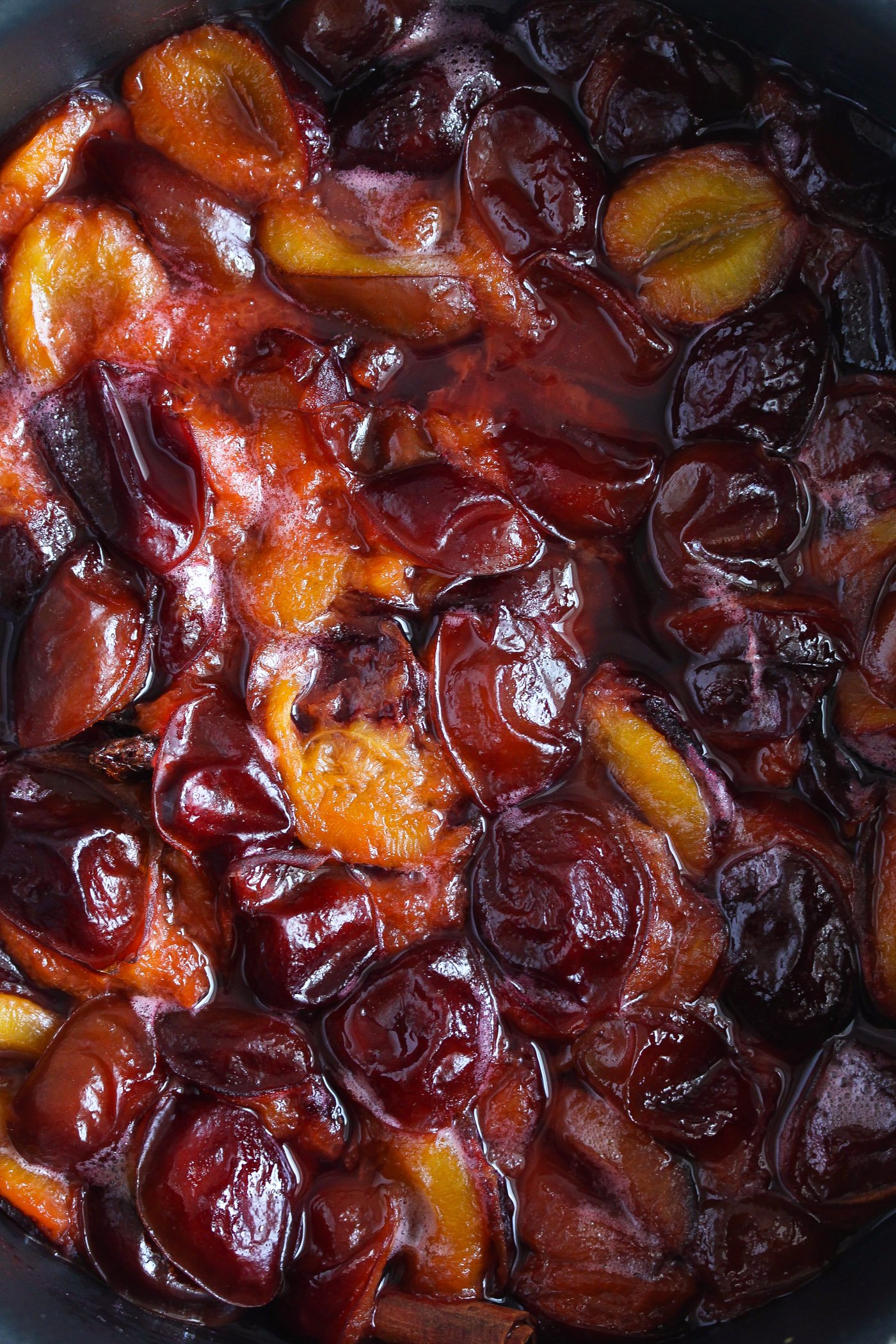 close up of red and shiny stewed plums