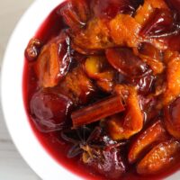 poached fruit in a white bowl