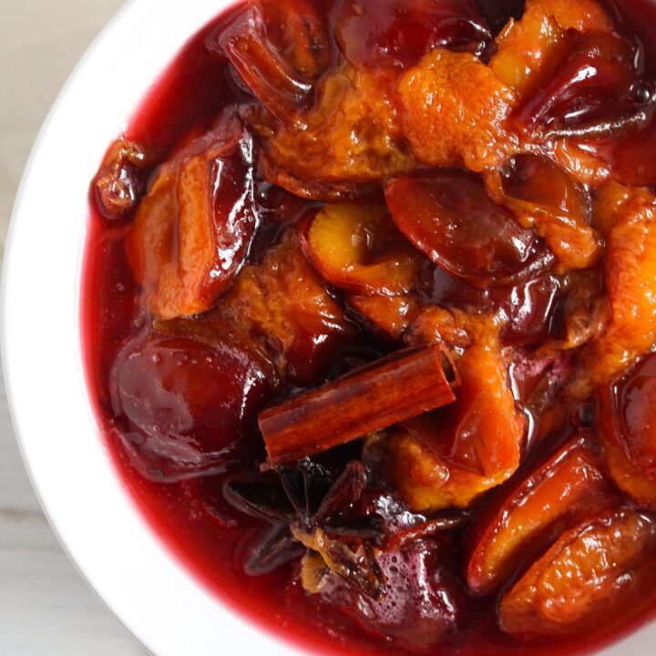 poached fruit in a white bowl