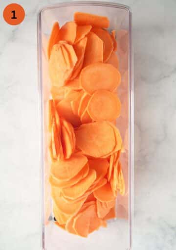 very thin sweet potato slices in the container of a mandolin slicer.