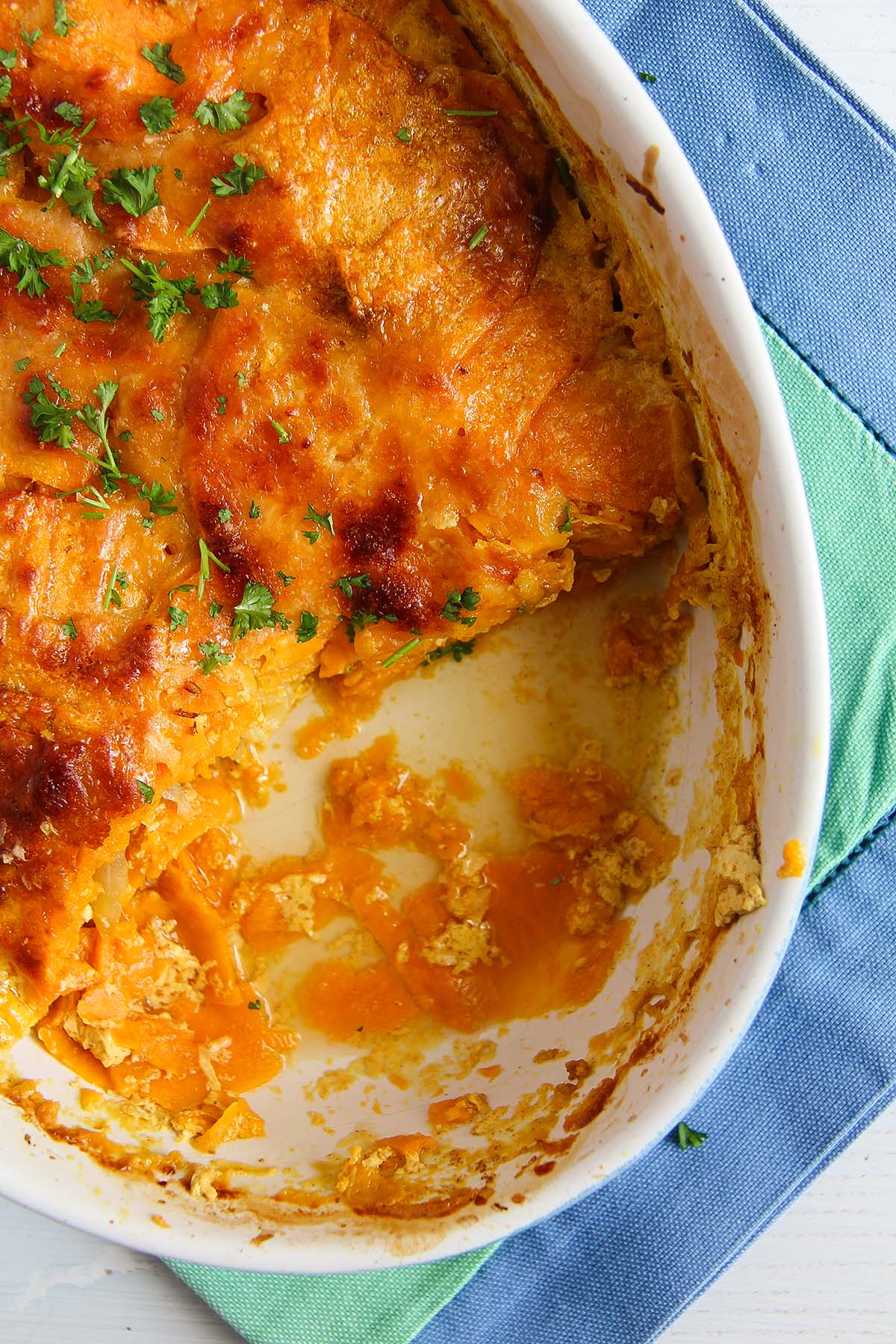 sweet potato dauphinoise half scooped out in a small baking dish.
