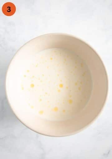 mixture of milk and heavy cream for making gratin in a bowl.