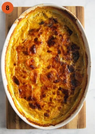 golden brown baked sweet potato gratin in a baking dish.
