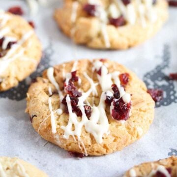 cranberry oatmeal walnut cookie drizzled with white chocolate