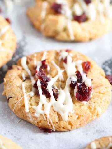 cranberry oatmeal walnut cookie drizzled with white chocolate