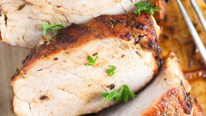 air fryer pork fillet sliced on a cutting board.