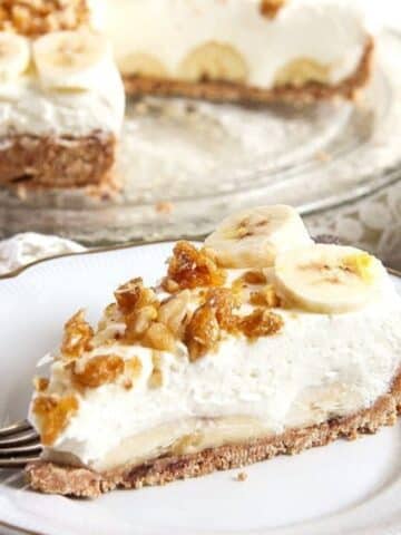 a super creamy slice of banana cream caramel pie topped with candied walnuts and banana slices.
