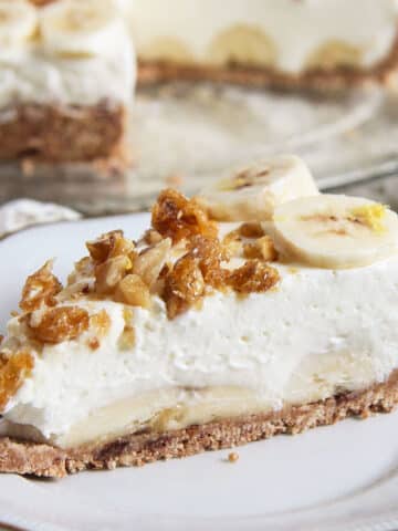 a super creamy slice of banana caramel cream pie on a small plate.