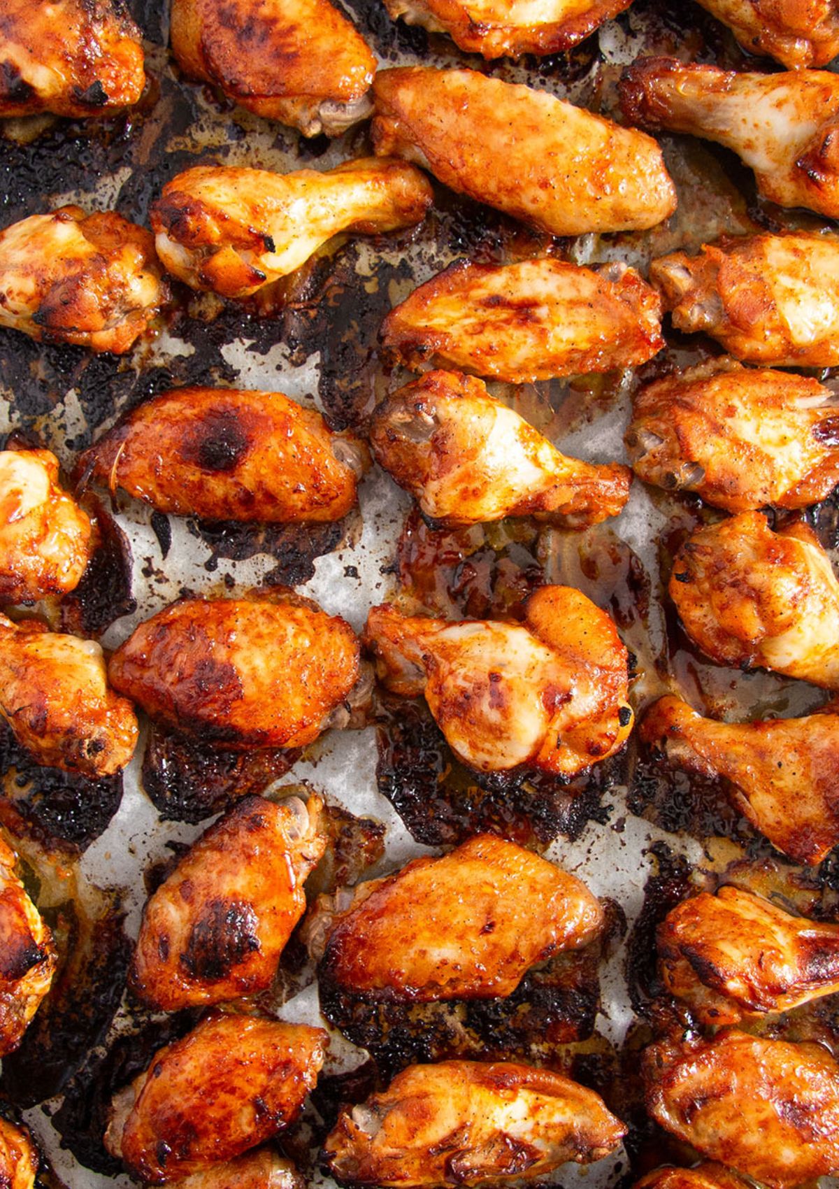 sticky baked korean wings on a baking sheet.