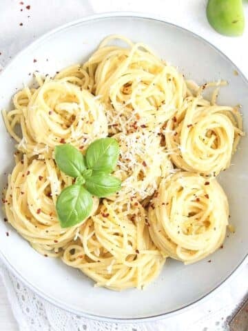 green tomato sauce with pasta in a white bowl