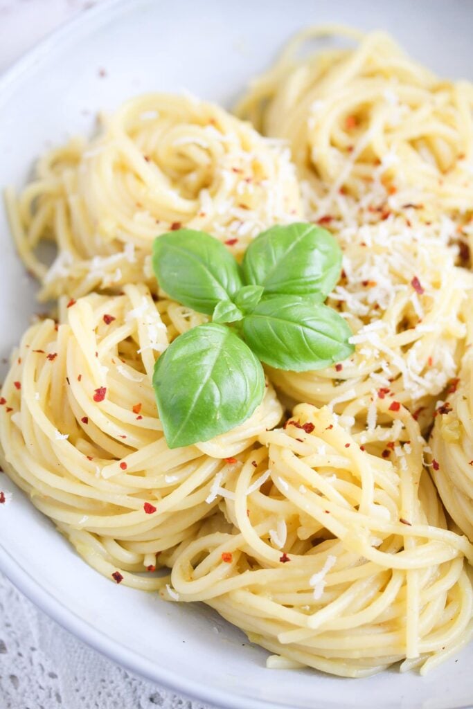 bowl of spaghetti served with green tomato sauce