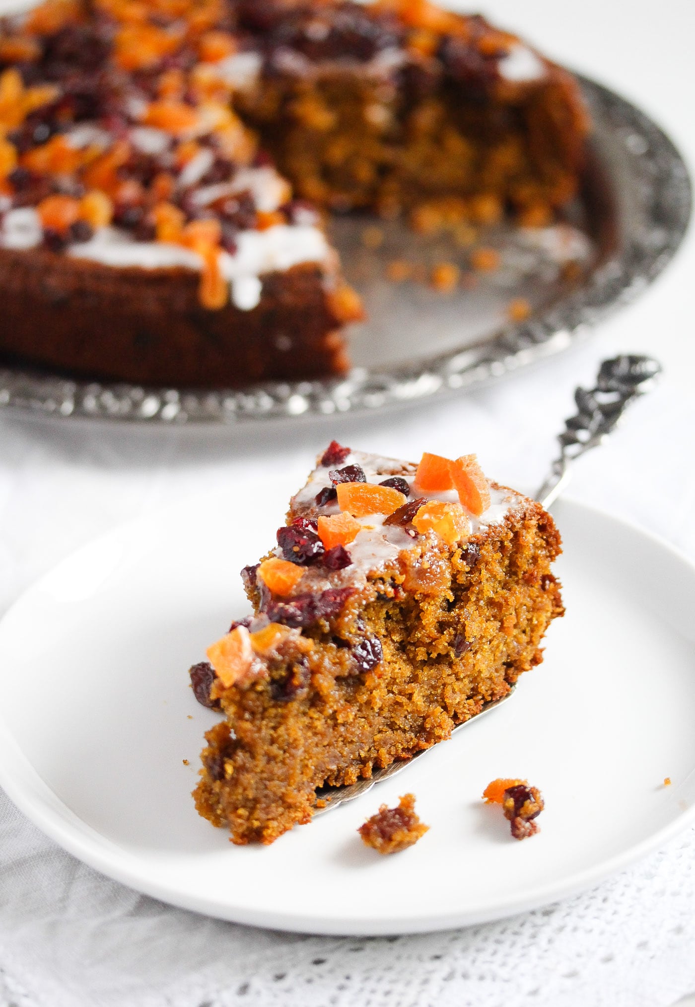 sliced piece of fruitcake with chopped apricots and raisins on top