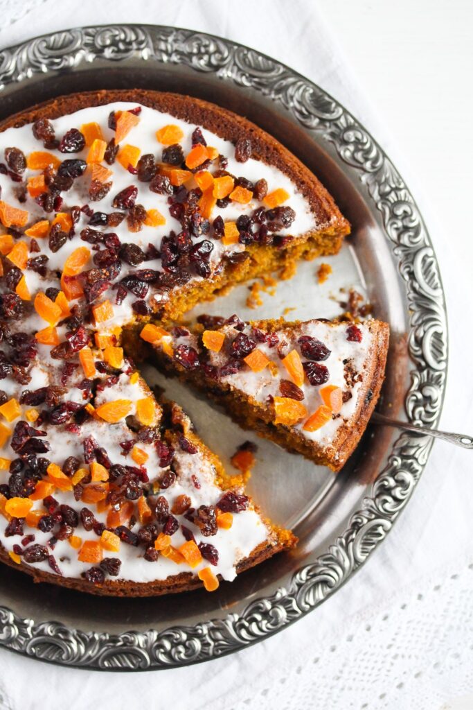 sliced large fruitcake with pumpkin puree on a silver platter