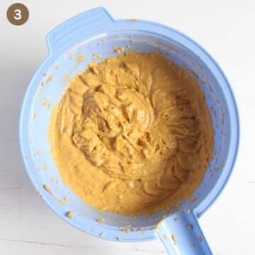 batter for pumpkin fruitcake in a blue bowl.