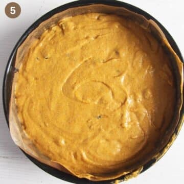 unbaked pumpkin fruitcake batter in a springform line with parchment paper.