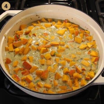cooking pumpkin cubes and rice in a pot with coconut milk.