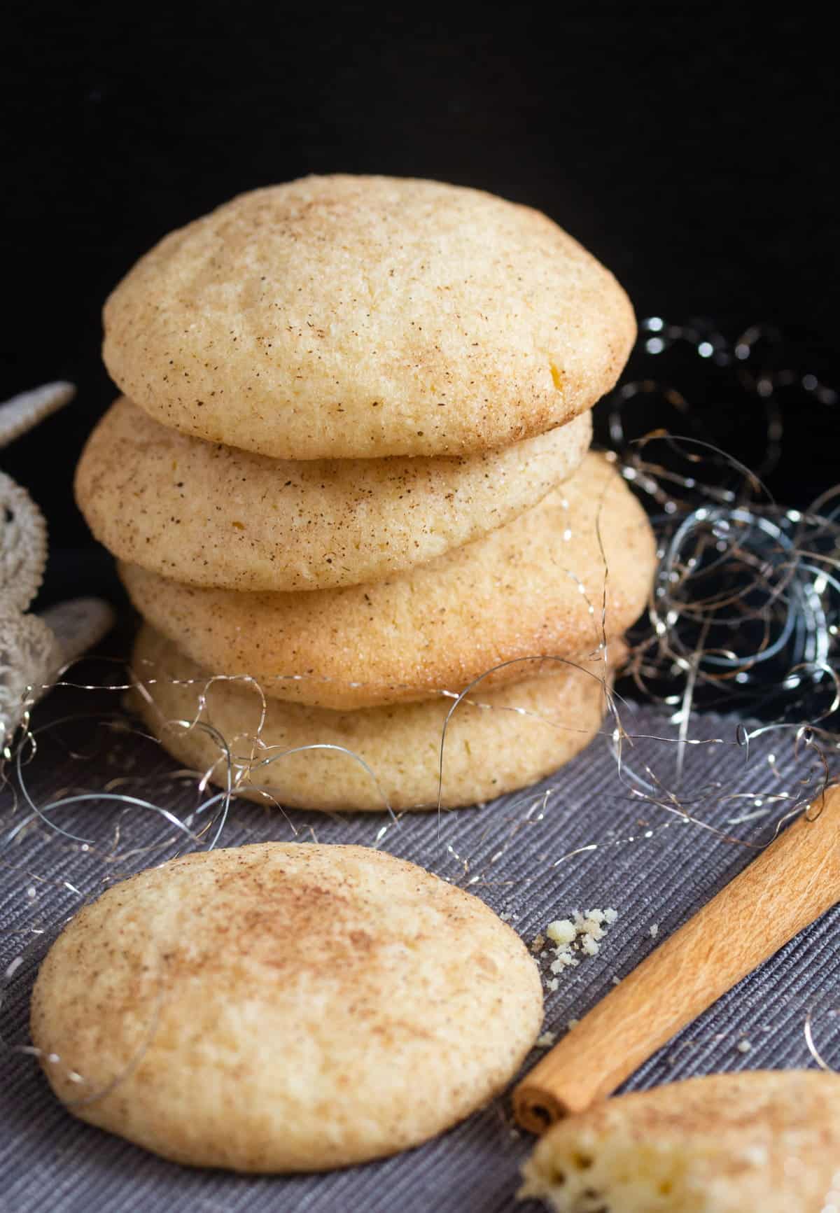 stack of snickerdoodles and a cinnamon stick.