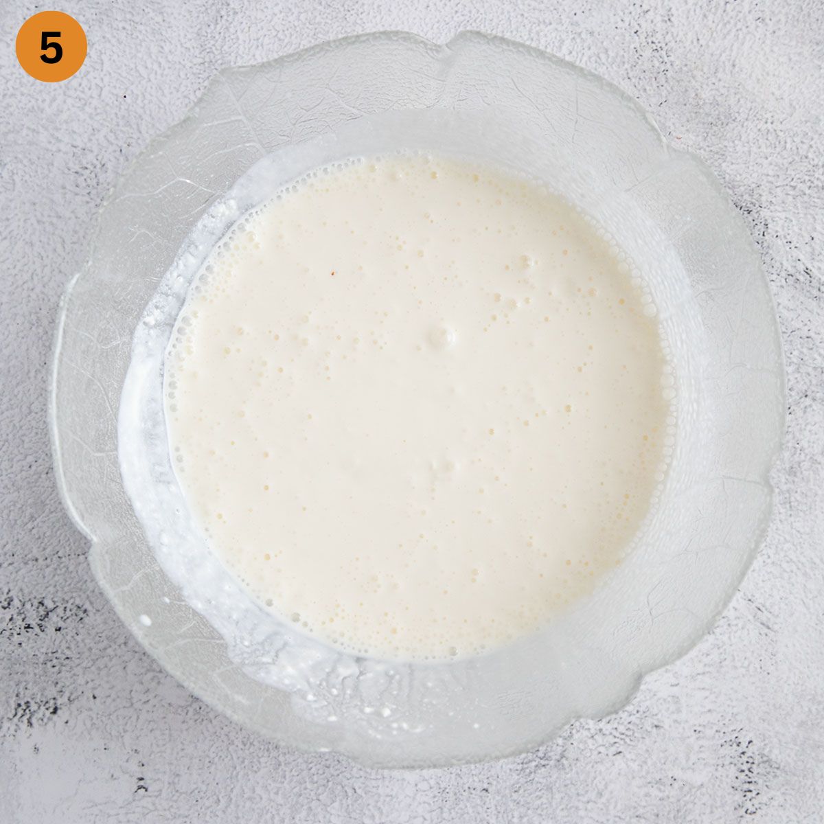 bowl with a mixture of cream cheese, cottage cheese, sour cream and milk for making lasagna.
