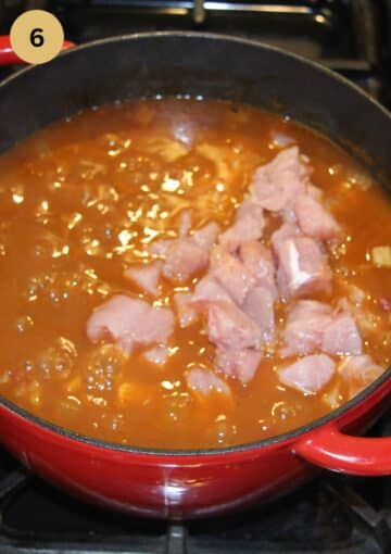 adding raw meat cubes to a pot of simmering soup.
