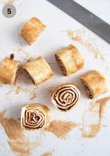 cut cinnamon and walnut dough rolls and a knife.