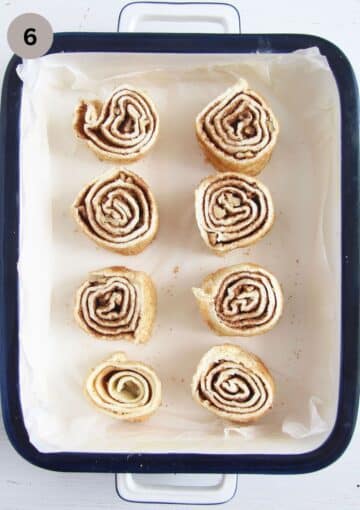 eight unbaked walnut swirls in a small baking dish.
