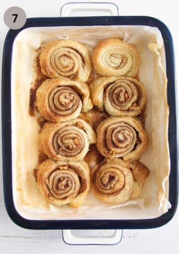 eight baked walnut swirls in a baking dish.