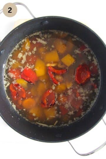 roasted vegetables in broth before blending them to a smooth soup.