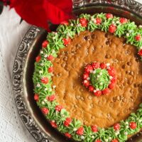 christmas cookie cake decorated with a green and red buttercream wreath.
