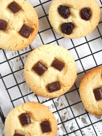 condensed milk cookies with chocolate chips on a wire rack