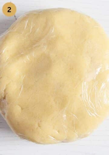 a disc of shortbread douch wrapped in plastic wrap-
