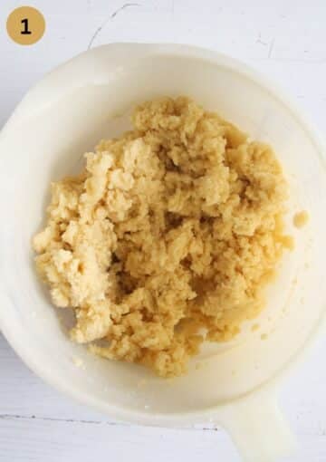 crumbly dough for making butter cookies in a mixing bowl.