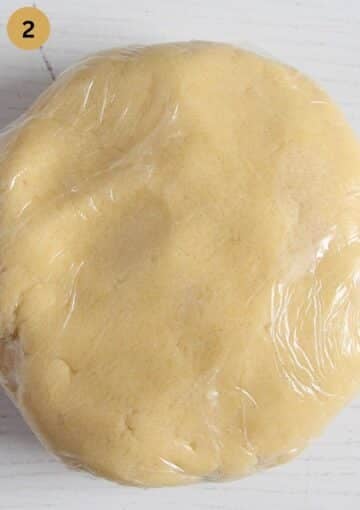 a ball of cookie dough wrapped in plastic wrap.