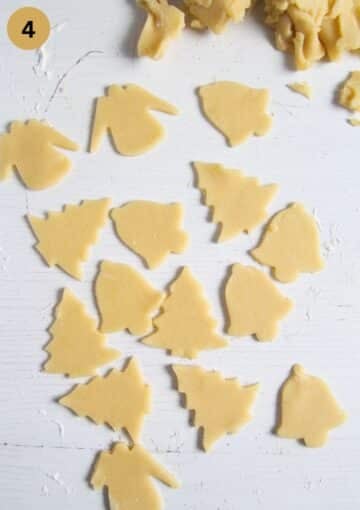 cut-out german butter cookies shaped like tree, angels and bells on the table.
