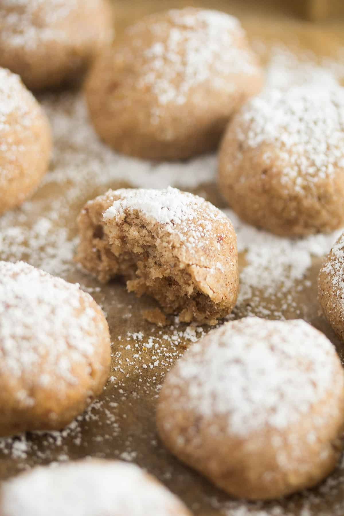 polvorones cookies, one with a bite taken out of it to show the crumbly texture.