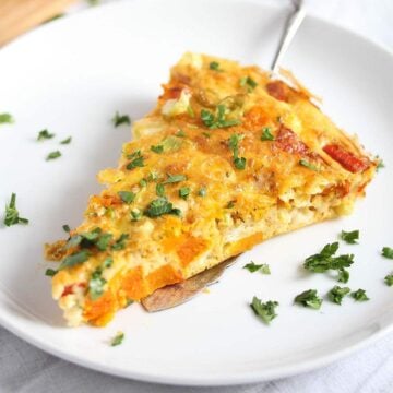 pumpkin frittata slice on a white small plate